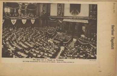 Foto des mit Gästen gefüllten und geschmückten Reichstags, am Rednerpult steht eine Person